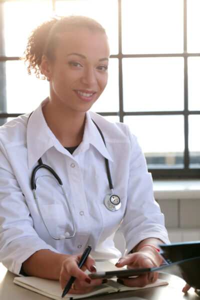 Medicine. Beautiful doctor by the table